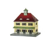 A Bub O Gauge Continental-style Station Building, on low rectangular platform with cream printed