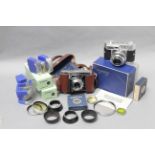 Voigtländer Cameras, a Vitomatic II in makers box, a Vito II a and a selection of hoods, filters and