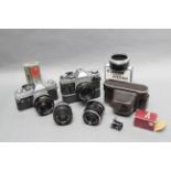 Canon Items, AE-1 and Ftb cameras with lenses and more including a rangefinder case with eagle logo