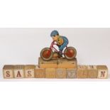 1930's Triang-Cord 935 X 135 Tin Plate toy bicycle and rider, painted red frame with lithographed