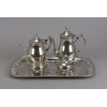 A four piece silver plated tea set, having floral decoration, together with a rectangular engraved
