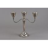 An Elizabeth II silver three branch candelabra, marked Birmingham 1975, by A.T Cannon Ltd, having