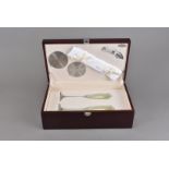 A cased champagne glass set, complete with white metal casters, together with a cased bottle opener,