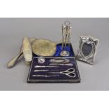 A cased silver manicure set, marked Birmingham by G&C Ltd, together with a silver manicure set on