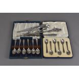 A collection of silver items, including two cased sets of teaspoons, silver handled cake forks and