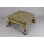 An Edwardian period brass covered hardwood table, on lion's paw legs, plus an Arts & Crafts ship