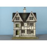 A German timber-framed dolls’ house, early 20th century, cream and grey painted, front door with