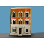 A large Silber & Fleming type box-backed dolls’ house, with brick and stone painted façade, yellow