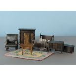 Dolls’ house furniture: oil-cloth armchair; four oak bedroom pieces, one stamped Elgin; a table