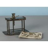 A fine brass miniature work bench, with working vice on simulated floor-boarded base, probably early