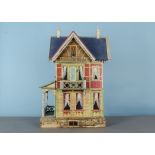 A Gottschalk blue-roofed dolls’ house, with printed paper façade, side porch with front door and
