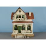 A Schönherr red-roofed dolls’ house 1920s, white painted with green doors, lintels and shutters,