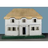 A Tri-ang No.1 Princess dolls’ house 1930s, with carved wooden thatched roof, pebble dashed walls,