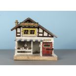A German ‘J. Bull’ Family Butchers dolls’ house probably by Schönherr, painted cream with timbered