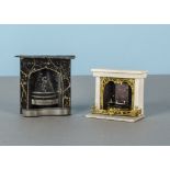 A tinplate dolls’ house fireplace, possibly Evans & Cartwright painted black with gold marbling -3¼
