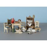 Dolls’ house kitchen furniture and chattels, a German cream painted table, an oak shelved buffet (