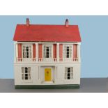 A large Tri-ang dolls’ house DH/3 1924, with cream painted façade, inset pillared porch with seats
