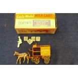 An early Moko Milk Cart, comprising orange cart, grey unpainted horse, driver and four crates, in