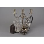 A collection of silver plated items, including a glass cruet set on stand, AF, a candelabra,