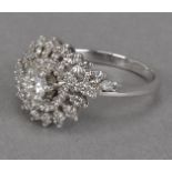 A 1970s 18ct white gold and diamond cluster ring, the eye shaped tablet set with brilliant cuts