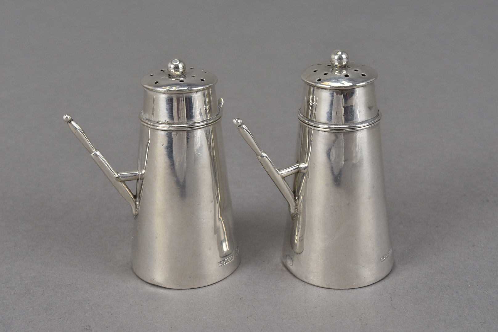 A pair of late Victorian silver novelty peppers, the shakers modelled as café au lait or chocolate