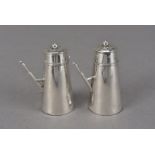 A pair of late Victorian silver novelty peppers, the shakers modelled as café au lait or chocolate