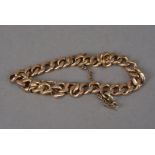 A vintage yellow metal gentleman's bracelet, the heavy flattened link chain with gold plated