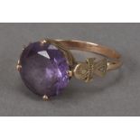 An Egyptian gold and synthetic colour changing Alexandrite solitaire dress ring