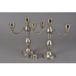 A pair of vintage silver filled candelabra by Duchin, having screw off three candle holder uppers,