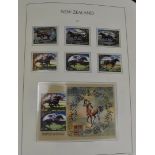 A comprehensive New Zealand stamp collection, in three green Leuchtturn folders, appears complete
