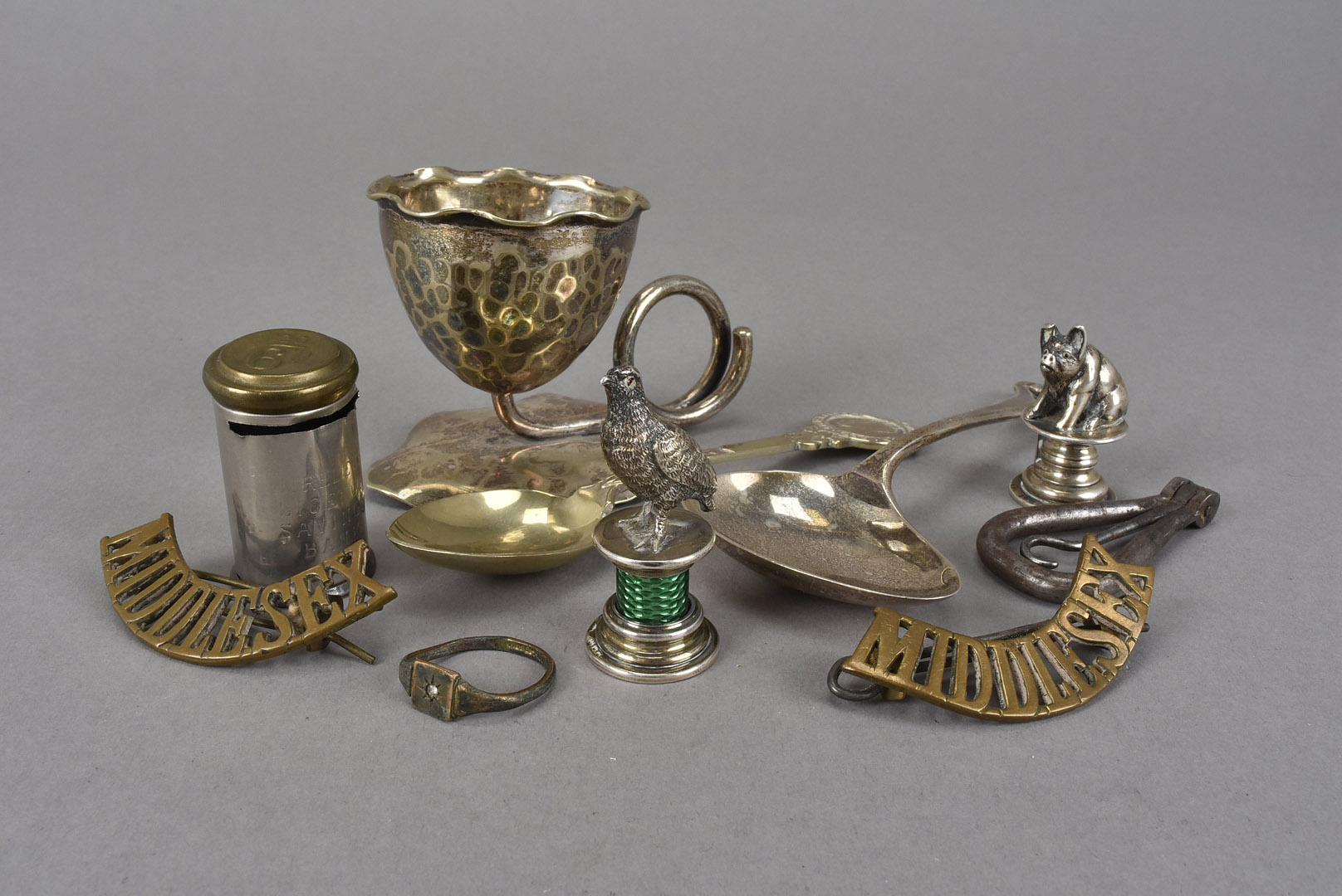 A continental silver and enamelled grouse desk seal, together with a small white metal pig menu