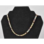 A modern yellow metal and gem set necklace, marked 750 to clasp, having oval collet set gems such as