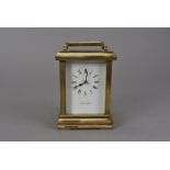 A modern brass carriage timepiece from Garrard & Co, the white enamel dial marked Garrard & Co Ltd ,