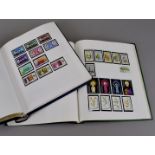 A group of four Commonwealth island stamp albums, one dedicated to Antigua from the 1950s to the