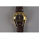 A modern Aigner horseracing themed wristwatch, the gold plated horseshoe shaped case, marked to