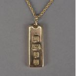 A modern 9ct gold ingot, hallmarked, on a yellow metal rope twist necklace, 42g