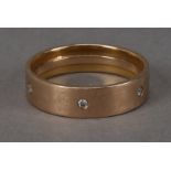 A modern gentleman's yellow metal and diamond wedding band, in rose gold and set with six small