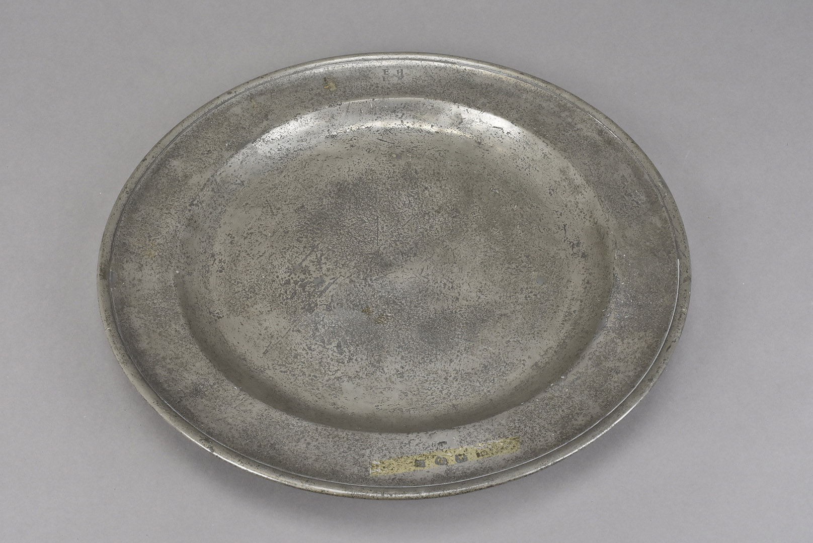 A late 17th century pewter charger, the circular dish stamped to lower and believed to be Edward