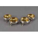 Two pairs of George III silver cauldron salts, extremely similar in design with three pad feet and