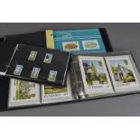 A collection of thirteen albums of modern presentation stamp sets, from Jersey, Guernsey and Isle of