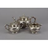 An Art Deco Chinese silver three piece tea set, marked SW, plain with raised dragon and bamboo