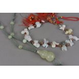 Two Chinese hardstone necklaces, one with green cord having double gourd and six beads, the other
