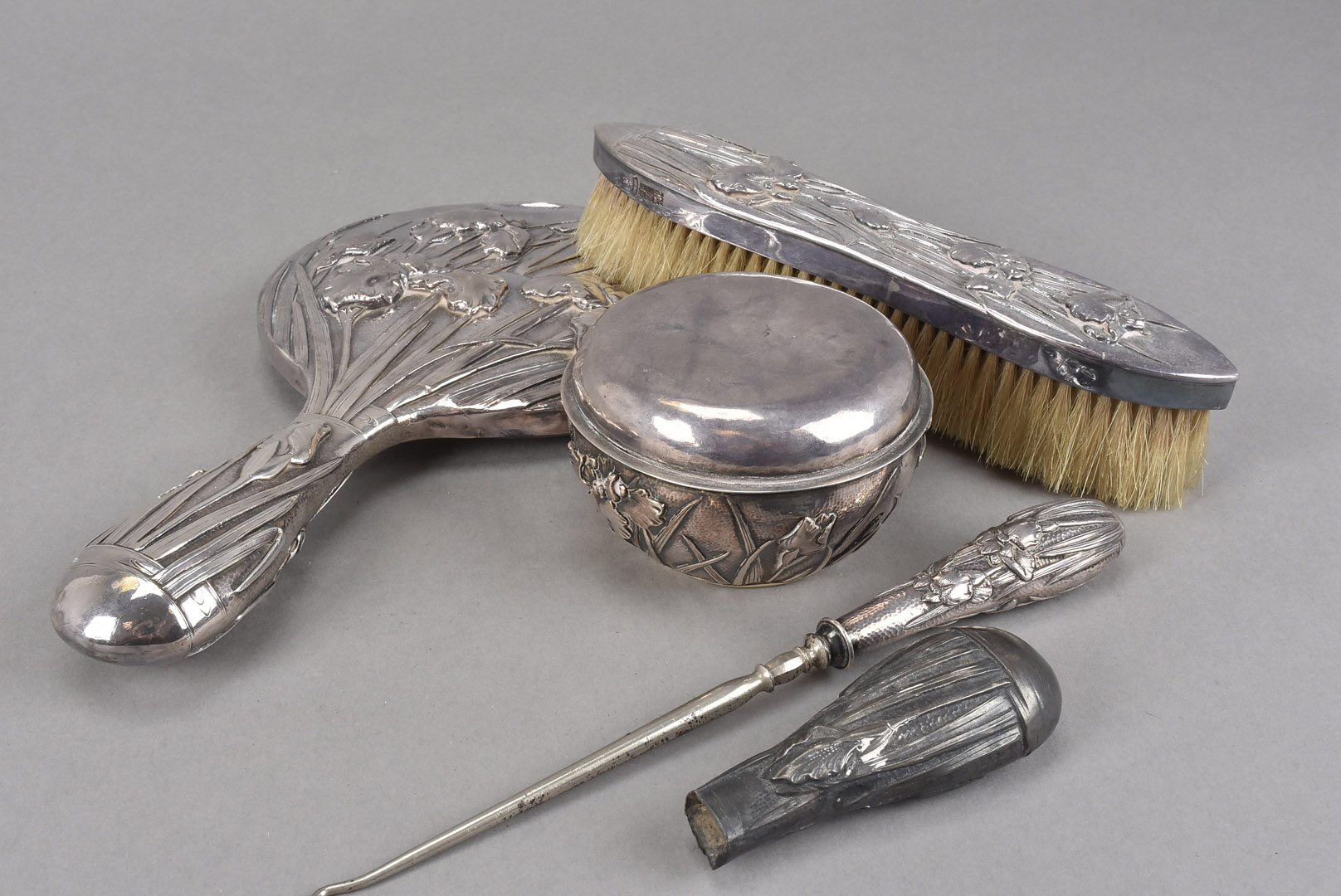 An Art Deco period Chinese silver part dressing table set, comprising covered pot, hand mirror,