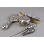 An Art Deco period Chinese silver part dressing table set, comprising covered pot, hand mirror,