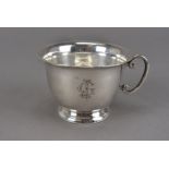 An early 20th century Continental white metal cup, with ear shaped handle and engraved monogram,