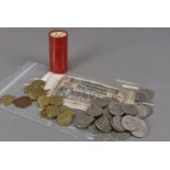 A collection of British coins, some in red card tubes, including three pences, half pennies, along