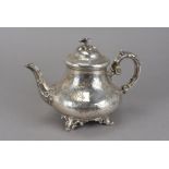 A Victorian silver teapot by Edward & John Barnard, with flower finial, engraved floral design and
