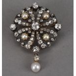 An Edwardian period diamond and pearl brooch cum pendant, circular pierced gold and silver mount set