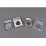 A group of four certified coins, each in plastic case, including an 1853 (NGC) and an 1854 half