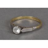 A modern 18ct gold and solitaire ring, the clear stone with platinum claws and shoulders, 2g and